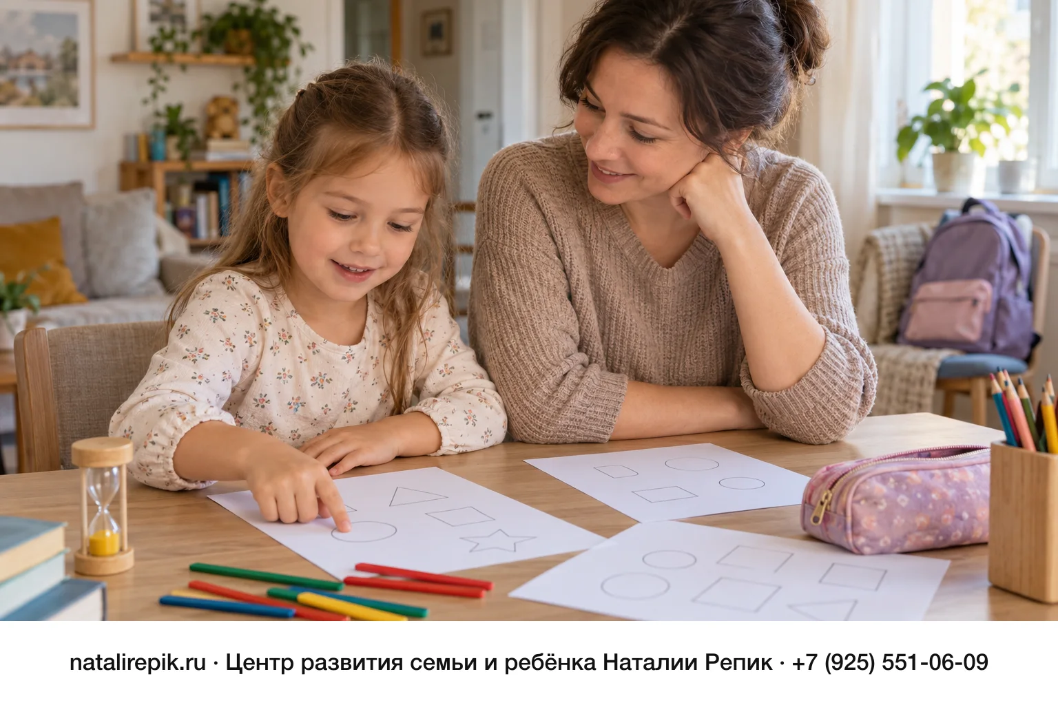 Мама и девочка лет шести за столом с листами, на которых нарисованы фигуры, песочными часами и счётными палочками; девочка показывает пальцем на лист, на стуле позади стоит новый школьный рюкзак