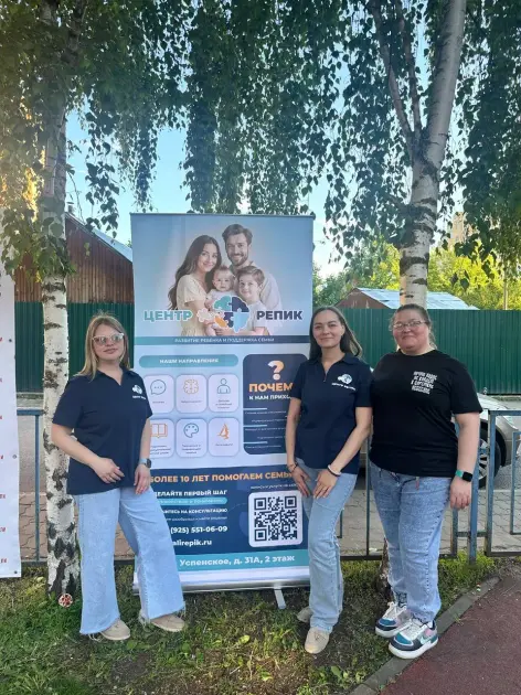 Команда центра Наталии Репик в фирменной форме у баннера на празднике